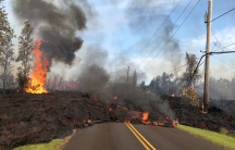 Lava advances along a street near a fissure in Leilani Estates, on Kilauea Volcano's lower East Rift Zone, Hawaii, May 5, 2018. 