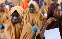 Some of the newly-released Dapchi schoolgirls wait to board a plane at the air force base in Maiduguri. 