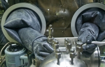 A worker at the Savannah River Site in South Carolina uses a glovebox to handle hazardous materials. The Savannah River Site is one of the locations the Trump administration is considering to host a ramp-up in nuclear warhead production.