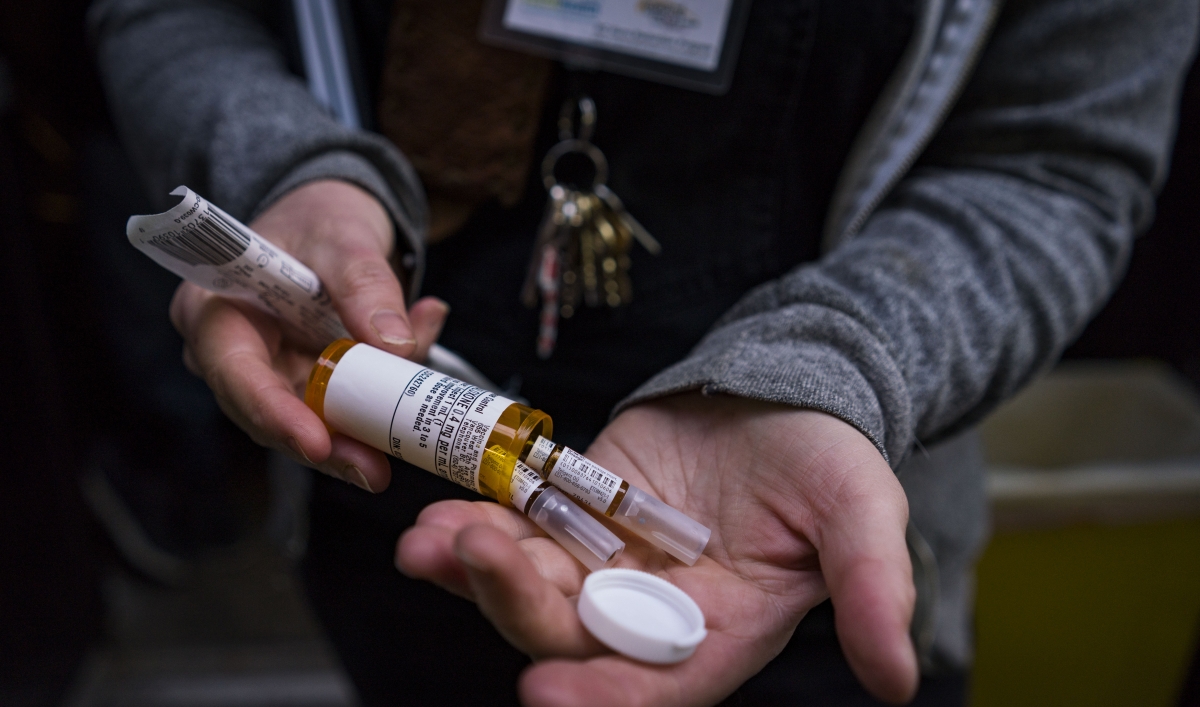 an overdose naloxone kit in a woman's hands