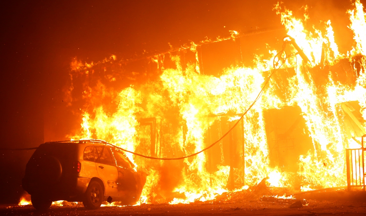 A structure is seen engulfed in flames during the Camp Fire