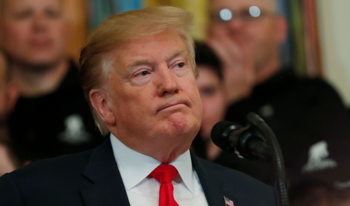 President Donald Trump is shown with his mouth closed looking off to his left.