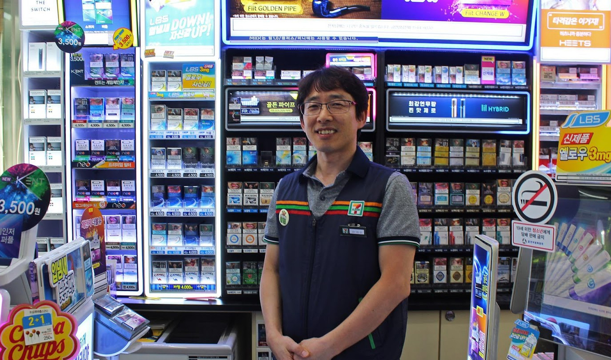 Man stands in 7-Eleven in work vest