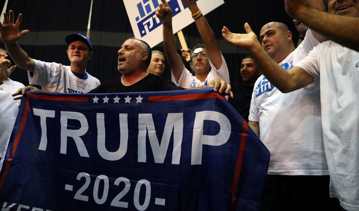 Supporters of Israeli Prime Minister Benjamin Netanyahu's Likud party react to exit polls in Israel's parliamentary election at the party headquarters in Tel Aviv, Israel, on Sept. 17, 2019. One sign says "Trump 2020" as well.