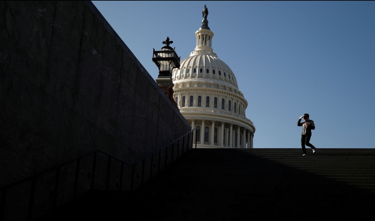 A visitor walks outside of the US Capitol