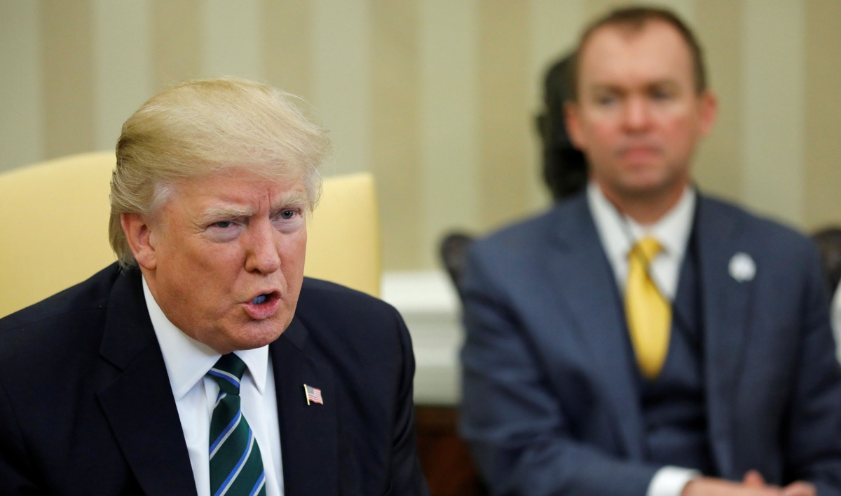 Office of Management and Budget (OMB) Director Mick Mulvaney (R) listens as President Donald Trump (L) meets with members of the Republican Study Committee