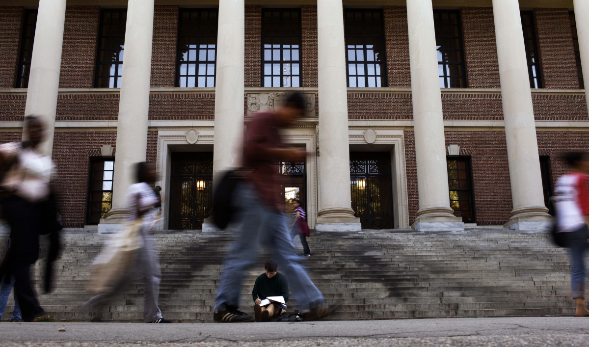 A students sits on the steps of Widener Library at Harvard University in Cambridge, Massachusetts, on Sept. 21, 2009.