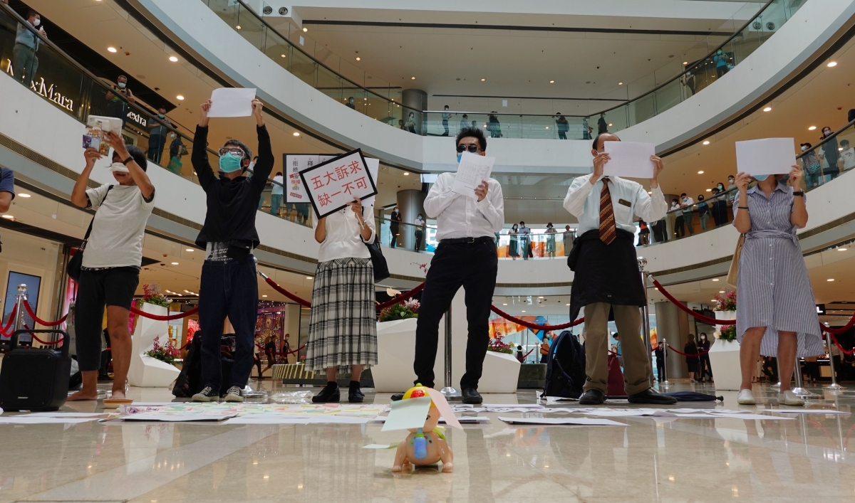 Pro-democracy demonstrators take part in a lunchtime protest against the national security law, at a shopping mall in Hong Kong, July 6, 2020.