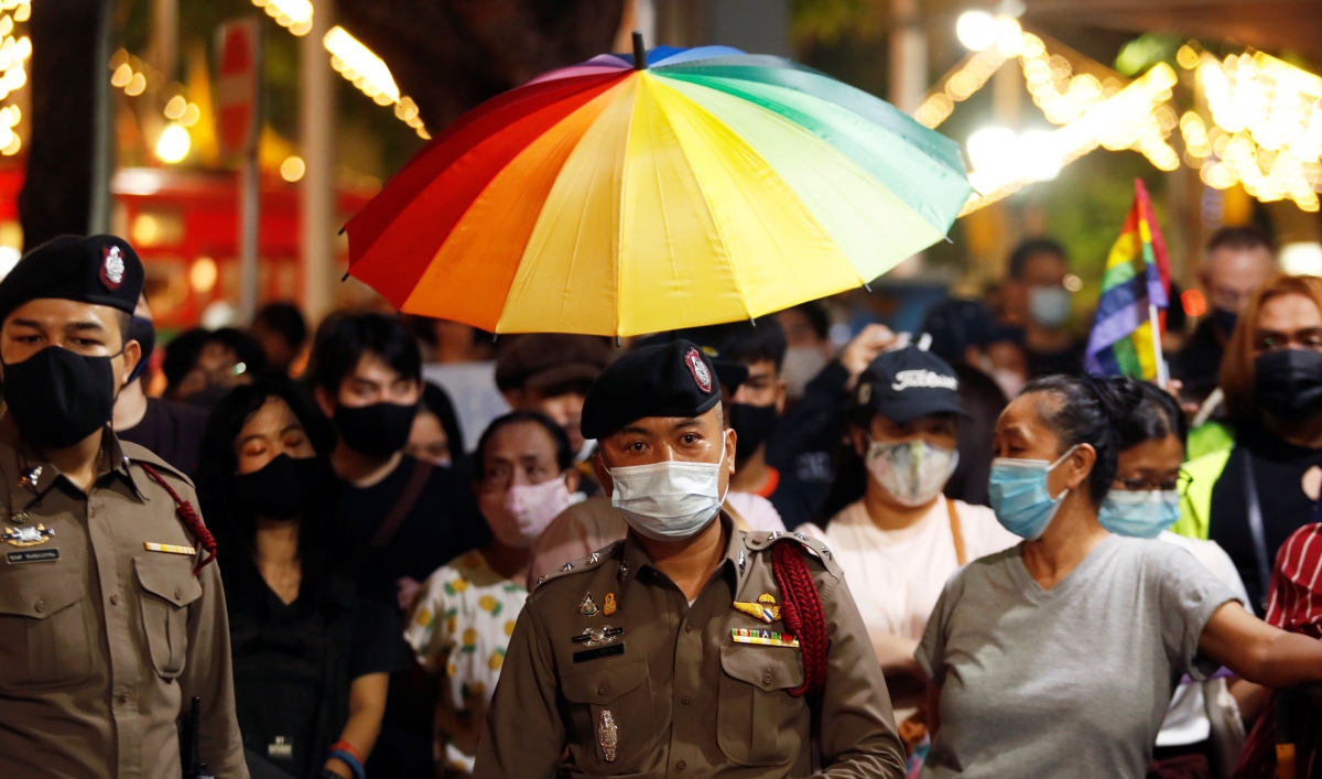Thai police officers stand among demonstrators during a protest demanding the resignation of Thailand's Prime Minister Prayuth Chan-o-cha, in Bangkok, Thailand, July 25, 2020.