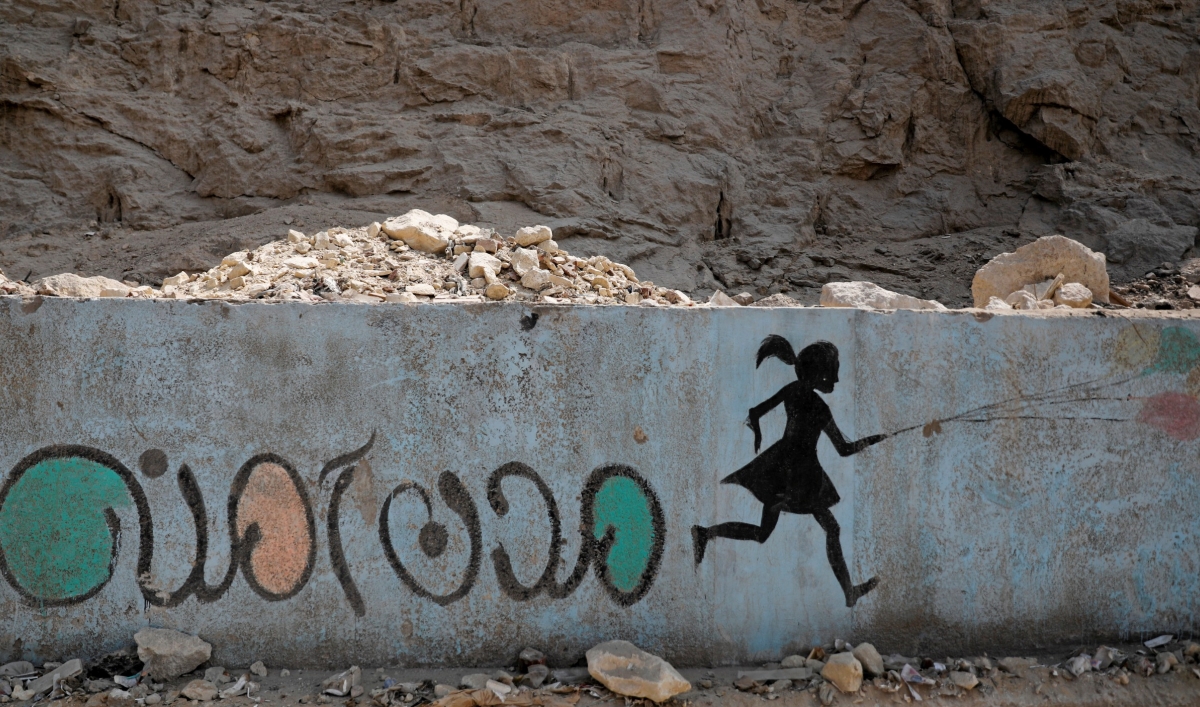 In this file photo, a mural depicting messages against sexual harassment and reading "safe cities" in Arabic script is seen on a highway in Cairo, Egypt, Sept. 3, 2018.