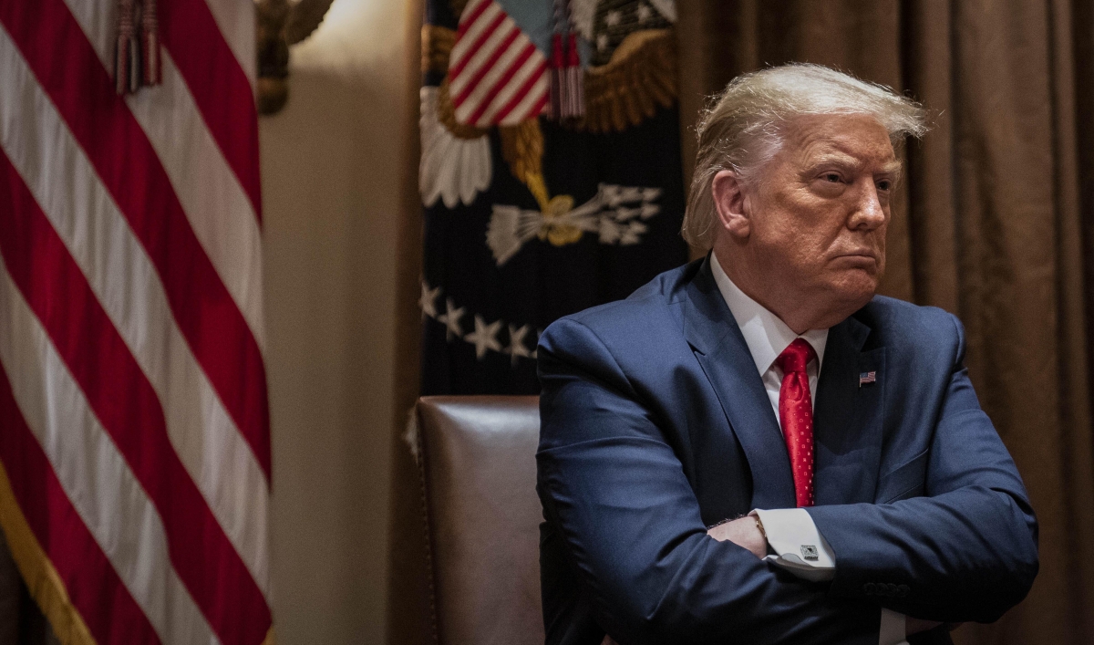 President Donald Trump crosses his arms as he listens during a White House meeting with Hispanic leaders, July 9, 2020, in Washington, DC.