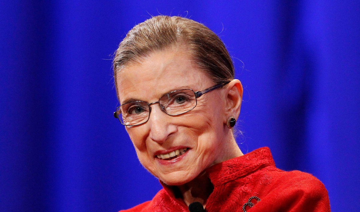 the late Supreme Court Justice Ruth Bader Ginsburg wears a bright red suit jacket