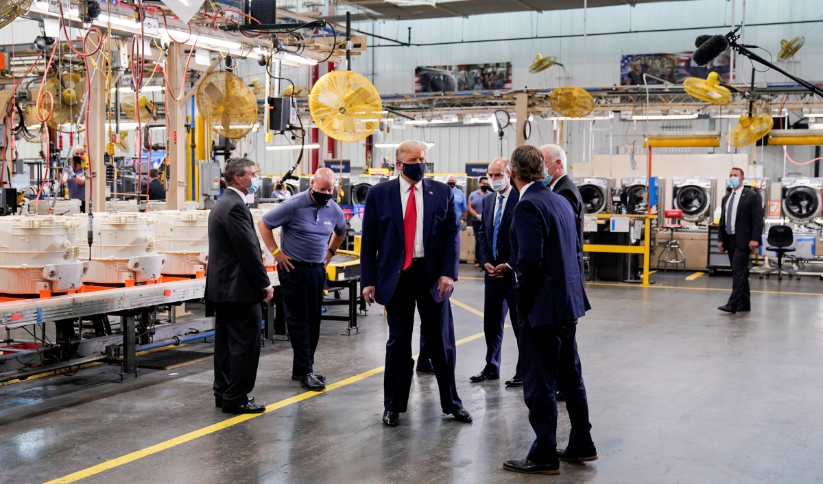 US President Donald Trump wears a protective face mask due to the coronavirus disease (COVID-19) pandemic as he tours the assembly line at a Whirlpool Corporation washing machine factory in Clyde, Ohio, Aug. 6, 2020.