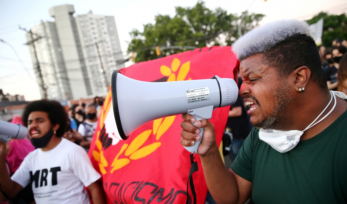 A demonstrator reacts during a protest against racism after João Alberto Silveira Freitas was beaten to death by security guards at a Carrefour supermarket in Porto Alegre, Brazil, Nov. 23, 2020.