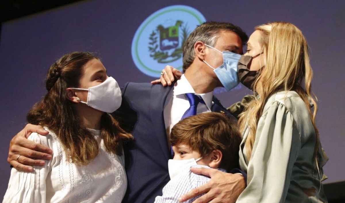 Venezuelan opposition leader Leopoldo López kisses his wife Lilian Tintori with their son and daughter after a news conference in Madrid on Oct. 27, 2020. López who has abandoned the Spanish ambassador's residence in Caracas and left Venezuela after years