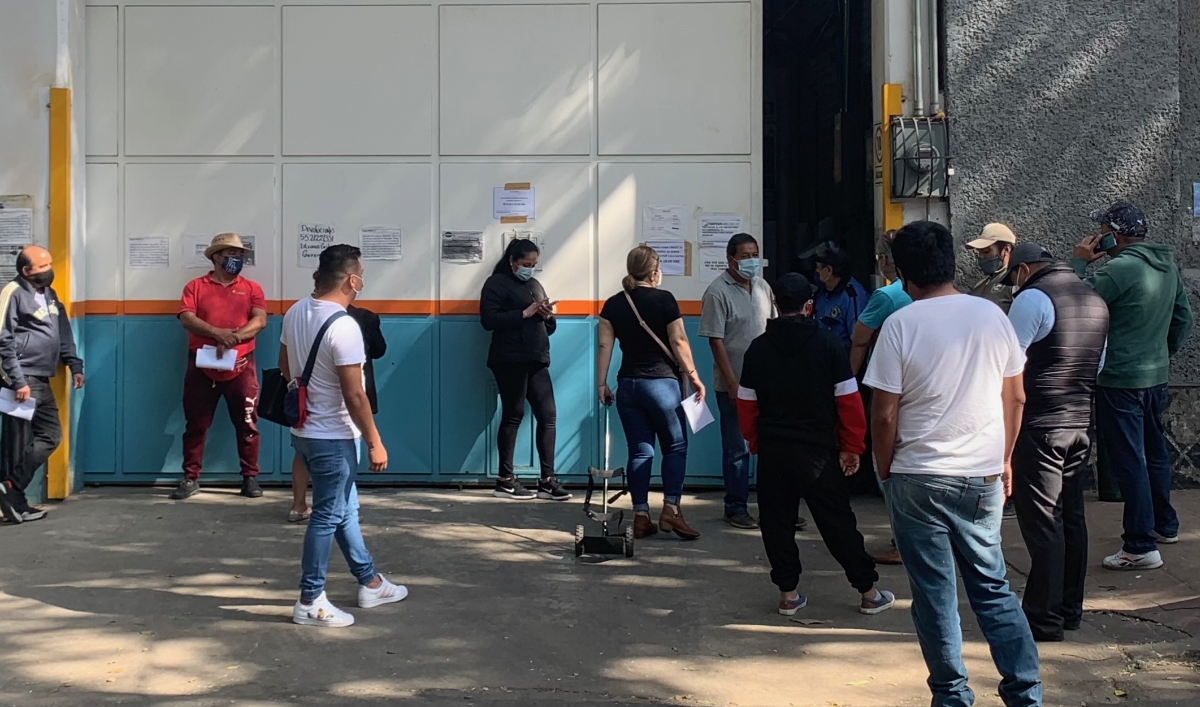 People wait in a long line at an oxygen distribution warehouse near downtown Mexico City.