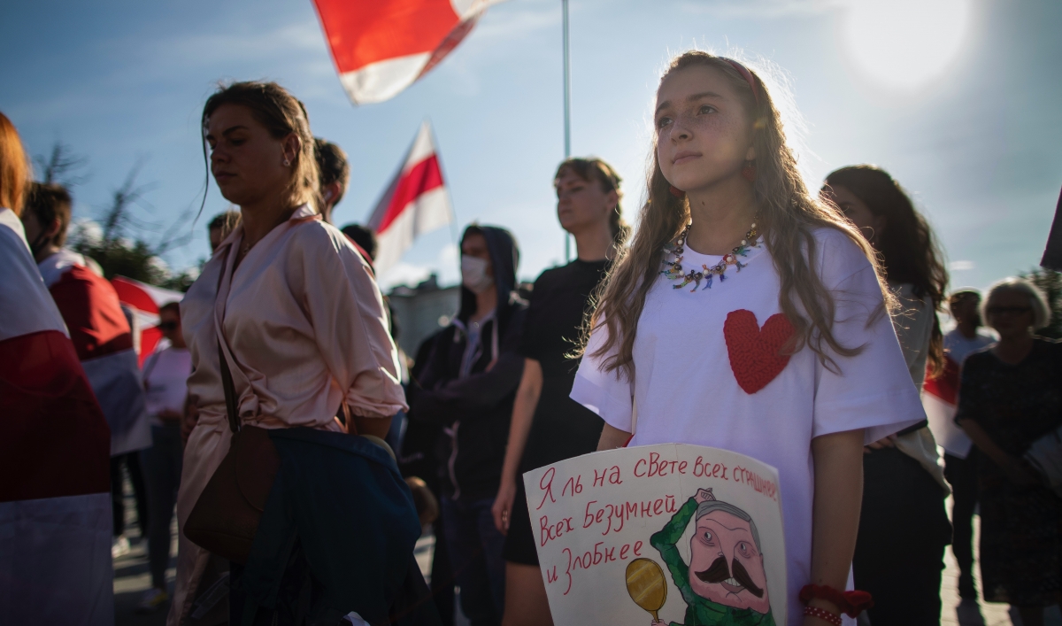 Protesters hold signs
