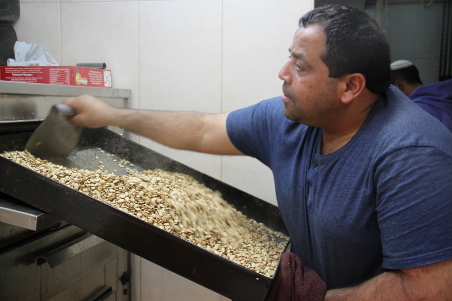Mohammed Shehada roasting watermelon seeds at Kahana Nuts. He has 30 years in the nut business. Mohammed Shehada roasting watermelon seeds at Kahana Nuts. He has 30 years in the nut business.