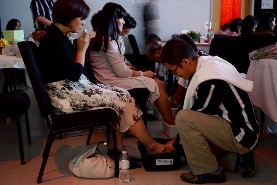 At the Father School graduation, men wash their wives' feet, just as Jesus washed the feet of his disciples in the Bible. At the Father School graduation, men wash their wives' feet, just as Jesus washed the feet of his disciples in the Bible.