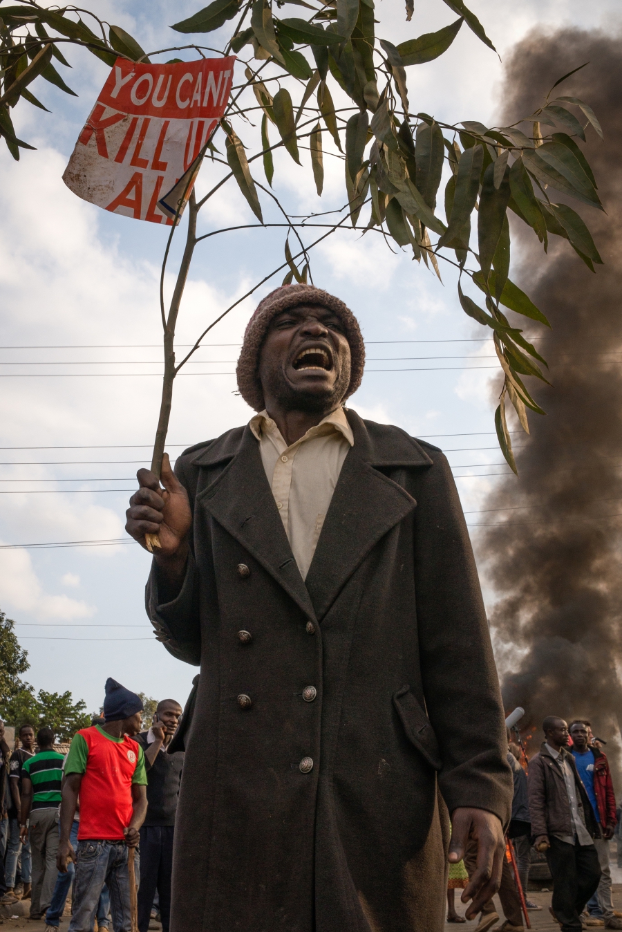 A man holds a sign that reads “you can’t kill us all” during a protest in an informal settlement in Nairobi, Kenya. Protesters were demanding that current President Uhuru Kenyatta concede to presidential candidate Raila Odinga of the opposition party. A man holds a sign that reads “you can’t kill us all” during a protest in an informal settlement in Nairobi, Kenya. Protesters were demanding that current President Uhuru Kenyatta concede to presidential candidate Raila Odinga of the opposition party.