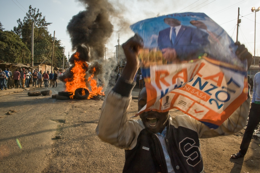 A man holds a campaign sign for presidential candidate Raila Odinga of the opposition party in the Kibera neighborhood of Nairobi, Kenya. Protesters were demanding that current President Uhuru Kenyatta concede to presidential candidate Raila Odinga of the A man holds a campaign sign for presidential candidate Raila Odinga of the opposition party in the Kibera neighborhood of Nairobi, Kenya. Protesters were demanding that current President Uhuru Kenyatta concede to presidential candidate Raila Odinga of the