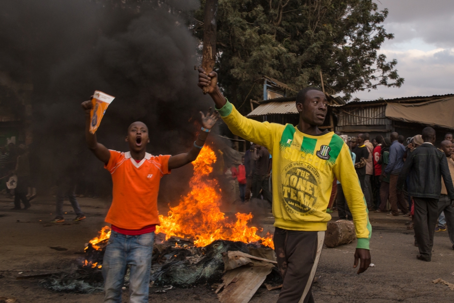 Men holding stones demand current President Uhuru Kenyatta step down from office. The demonstration came one day after Kenyans went to the polls to elect their next president. Men holding stones demand current President Uhuru Kenyatta step down from office. The demonstration came one day after Kenyans went to the polls to elect their next president.