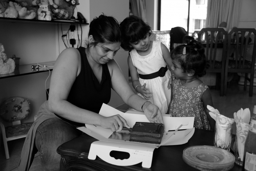 Ayesha D'Souza cuts some chocolate cake for her daughter and five-year-old friend Aliesha, also adopted. Ayesha D'Souza cuts some chocolate cake for her daughter and five-year-old friend Aliesha, also adopted.