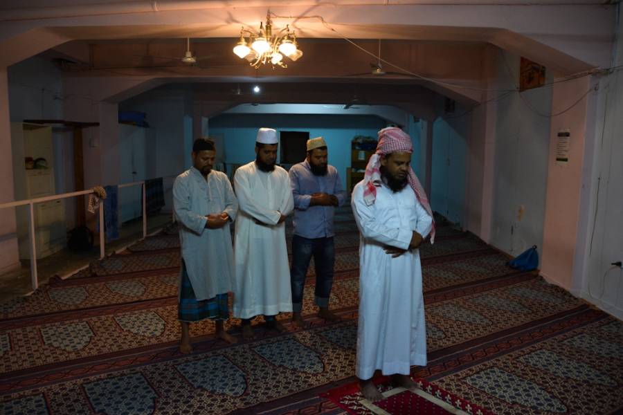 Men from Bangladesh pray on a Friday afternoon at the Hazrat e Umar prayer room in the neighborhood of Kato Patisia, Athens. Men from Bangladesh pray on a Friday afternoon at the Hazrat e Umar prayer room in the neighborhood of Kato Patisia, Athens.
