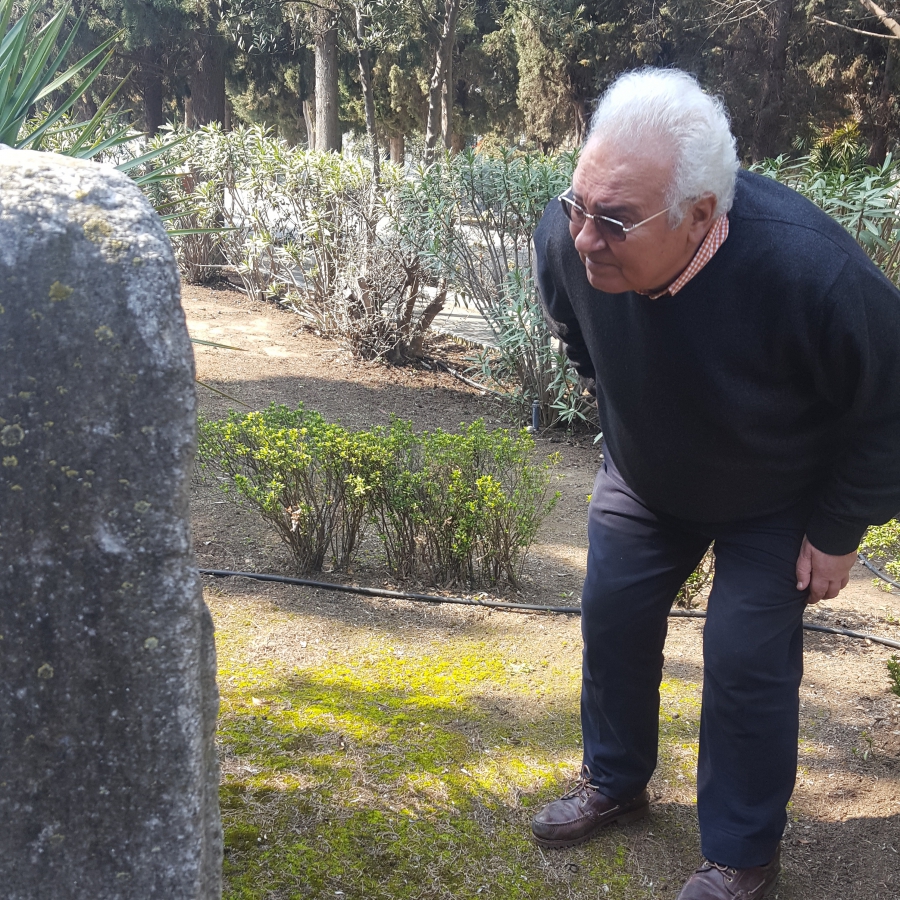 Jacky Benmayor stoops down to get a better look at an old tombstone at the newer Jewish cemetery. Jacky Benmayor stoops down to get a better look at an old tombstone at the newer Jewish cemetery.