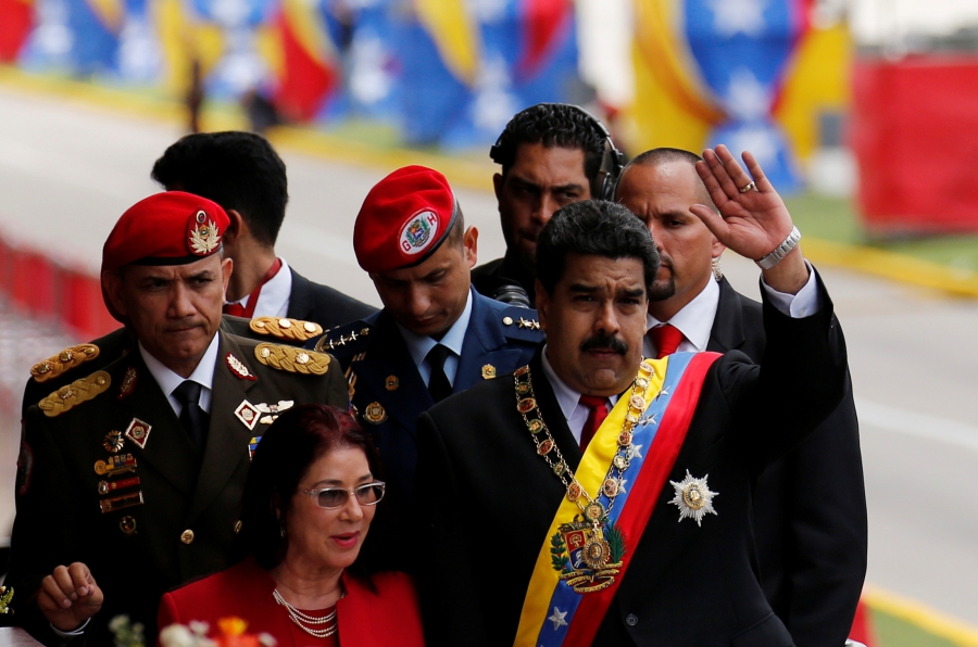 Venezuela's President Nicolas Maduro waves to the media next to his wife Cilia Flores after the military parade to celebrate the 205th anniversary of Venezuela's independence in Caracas, Venezuela July 5, 2016. Venezuela's President Nicolas Maduro waves to the media next to his wife Cilia Flores after the military parade to celebrate the 205th anniversary of Venezuela's independence in Caracas, Venezuela July 5, 2016.