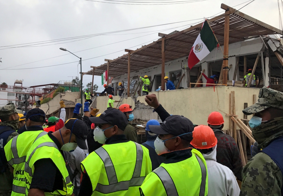 Soldiers and rescue workers gesture for people to be quiet as they search in the rubble for students of the Enrique Rebsamen school after an earthquake hit Mexico City, on Sept. 20, 2017. Soldiers and rescue workers gesture for people to be quiet as they search in the rubble for students of the Enrique Rebsamen school after an earthquake hit Mexico City, on Sept. 20, 2017.