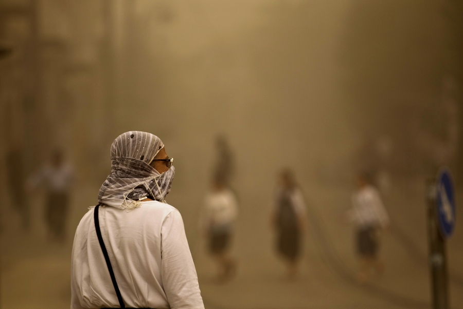A pedestrian walks with a covered face during a sandstorm in Jerusalem September 8. Clouds of dust have engulfed Israel, Jordan and Cyprus. A pedestrian walks with a covered face during a sandstorm in Jerusalem September 8. Clouds of dust have engulfed Israel, Jordan and Cyprus.