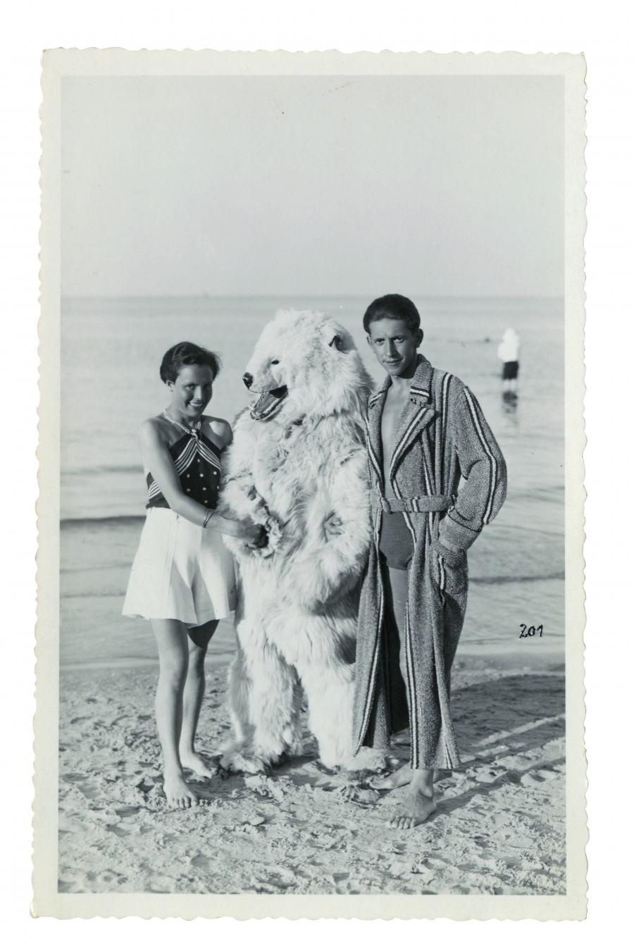A man in a polar bear suit poses with a young German couple A man in a polar bear suit poses with a young German couple
