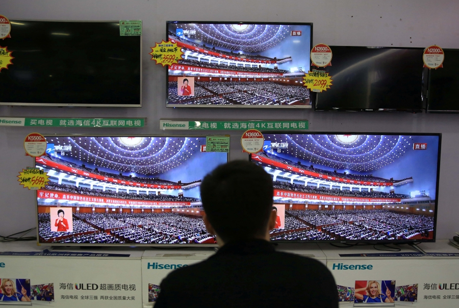 A man watches a broadcast of Chinese President Xi Jinping delivering his speech during the opening of the 19th National Congress of the Communist Party of China. A man watches a broadcast of Chinese President Xi Jinping delivering his speech during the opening of the 19th National Congress of the Communist Party of China.