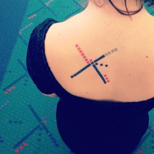 A woman shows her tattoo based on the design of the carpet at the Portland airport. A woman shows her tattoo based on the design of the carpet at the Portland airport.