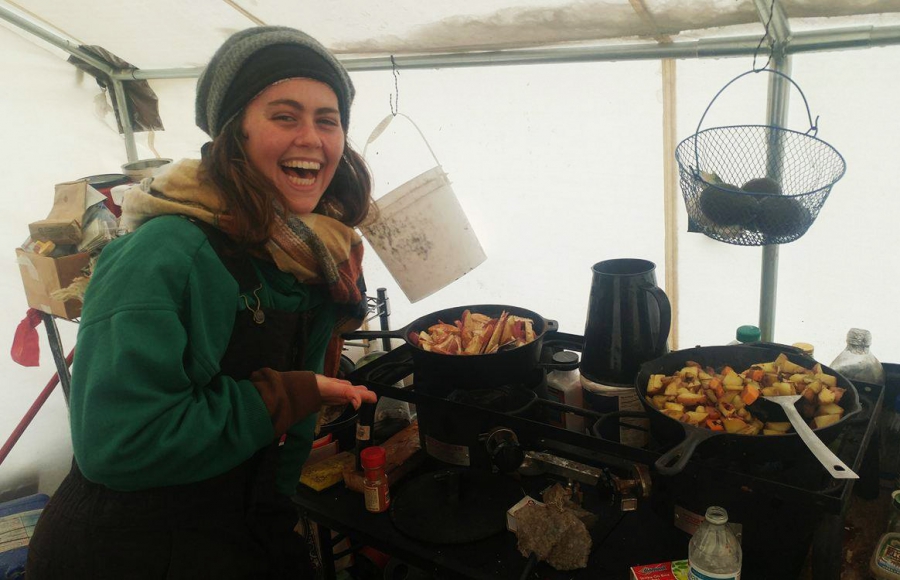 Campers cook in a tent