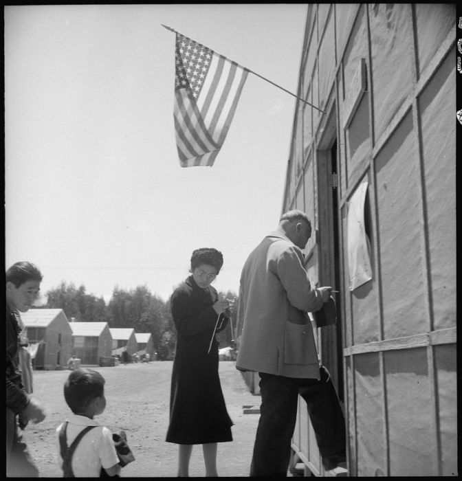 People walking up steps to enter building