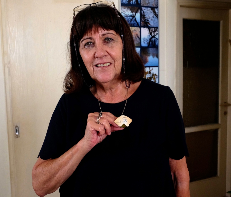 Linguist Arik Sadan's mother, Drora, holding her son's “To my mother with love” inscription, written in Hebrew and Arabic. Linguist Arik Sadan's mother, Drora, holding her son's “To my mother with love” inscription, written in Hebrew and Arabic.