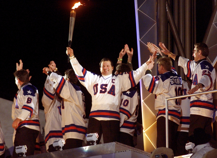 Members of the gold-medal winning 1980 US Olympic hockey team wave as their former team captain, Mike Eruzione, holds the Olympic torch during the opening ceremony of the Salt Lake 2002 Olympic Winter Games, February 8, 2002. Members of the gold-medal winning 1980 US Olympic hockey team wave as their former team captain, Mike Eruzione, holds the Olympic torch during the opening ceremony of the Salt Lake 2002 Olympic Winter Games, February 8, 2002.
