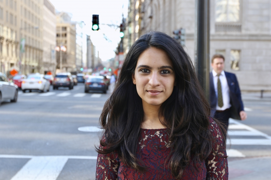 A woman looks at the camera and smiles.