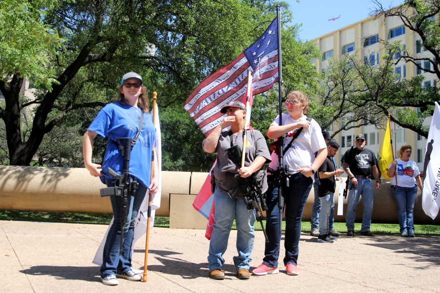 Emily (far left) and Nicole Defosse (far right, holding the "2nd Amendment American Flag") held unloaded AR 15s as they stood in counter-protest roughly 50 yards away from a rally held in support of stricter gun control legislation outside of city hall on
