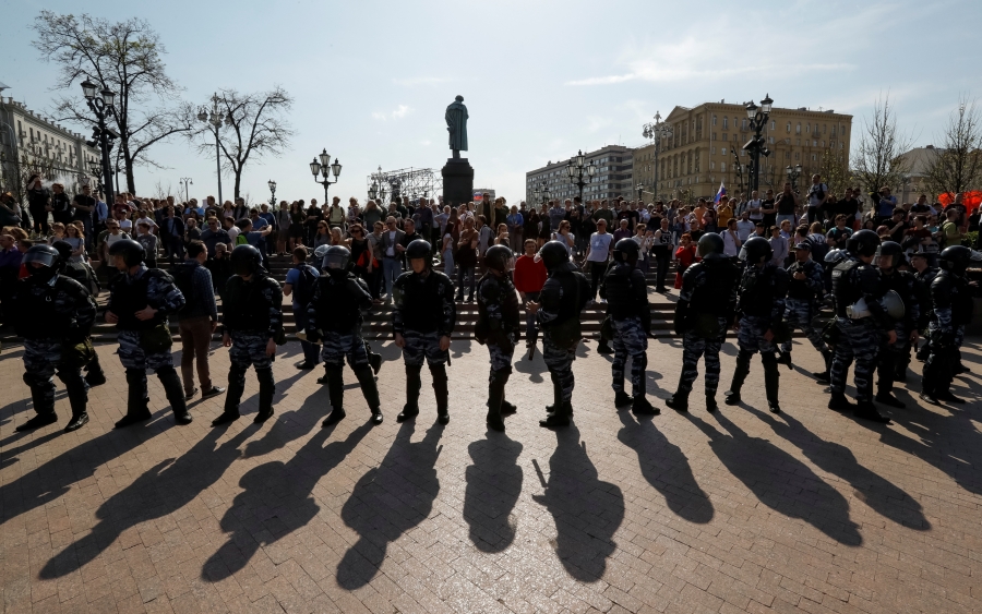 Police officers in riot gear block an area during an opposition protest rally ahead of Vladimir Putin's inauguration ceremony, next to the monument to Russian poet Alexander Pushkin, in Moscow, Russia, May 5, 2018.
