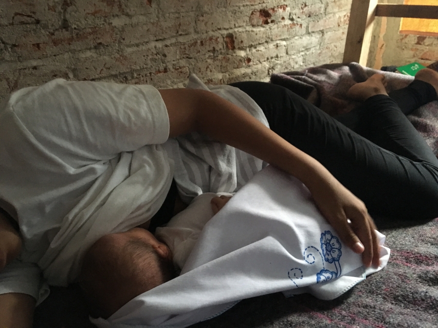 Woman lying on her side with child