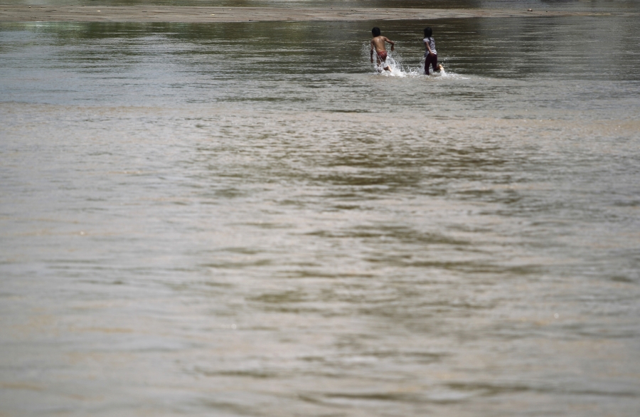 Gray water with children running across