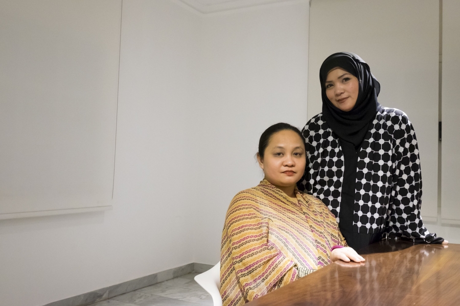 Sandigan co-founder Ann Abunda poses with Aysha, an organization volunteer who asked to be identified by her first name over security concerns. Abunda's group spearheaded the medical mission at the Philippine embassy in March. Credit: Alisa Reznick/PRI