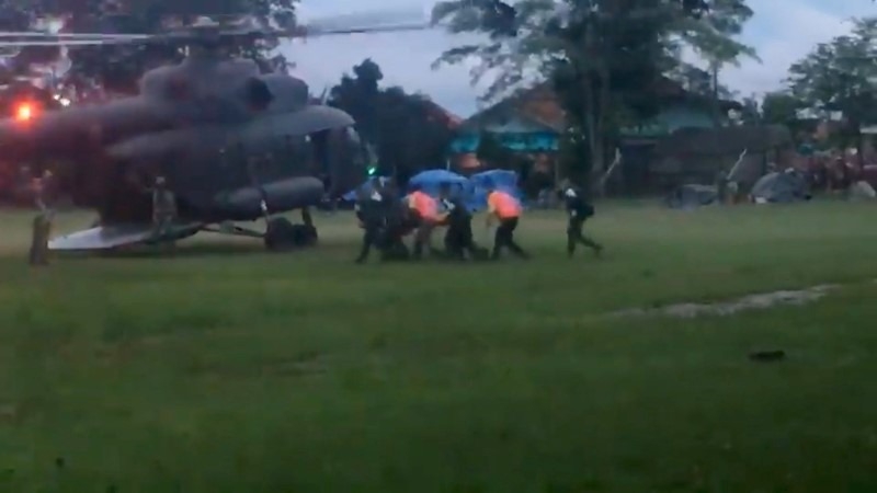 Paramedics, believed to be carrying a boy who has been evacuated after being trapped inside a flooded cave, approach a helicopter in Chiang Rai, Thailand, July 8, 2018, in this still image obtained from social media. Paramedics, believed to be carrying a boy who has been evacuated after being trapped inside a flooded cave, approach a helicopter in Chiang Rai, Thailand, July 8, 2018, in this still image obtained from social media.