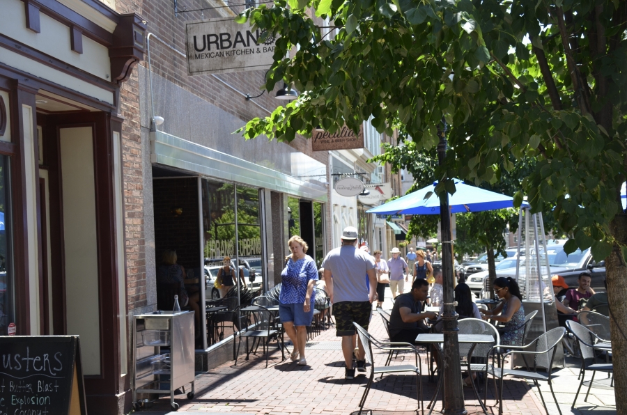 Downtown Bethlehem, PA. People sit at tables on sidewalks on a city street