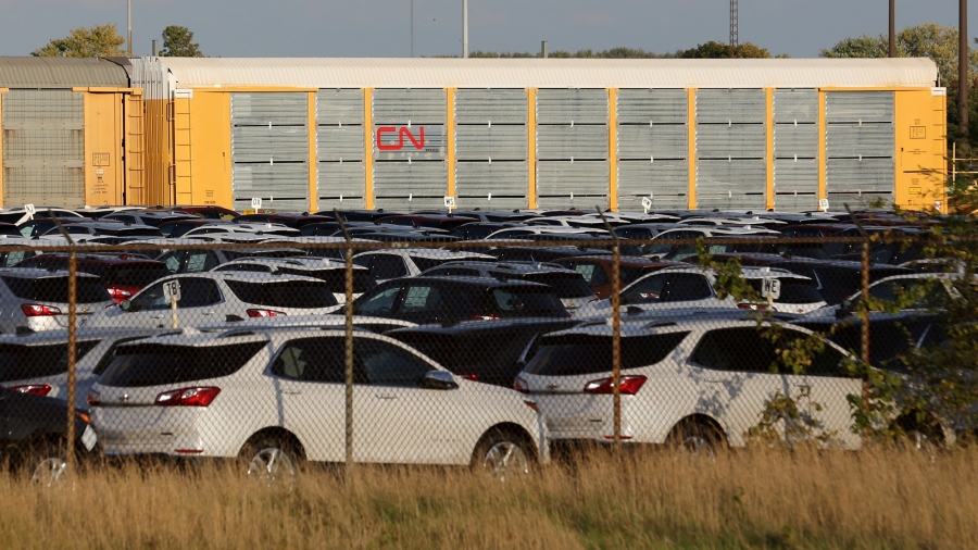 Chevrolet Equinox SUVs are parked awaiting shipment by CN Rail next to the General Motors CAMI assembly plant in Ingersoll, Ontario. Chevrolet Equinox SUVs are shown parked in a fenced in area with CN Rail cars in tbe background.