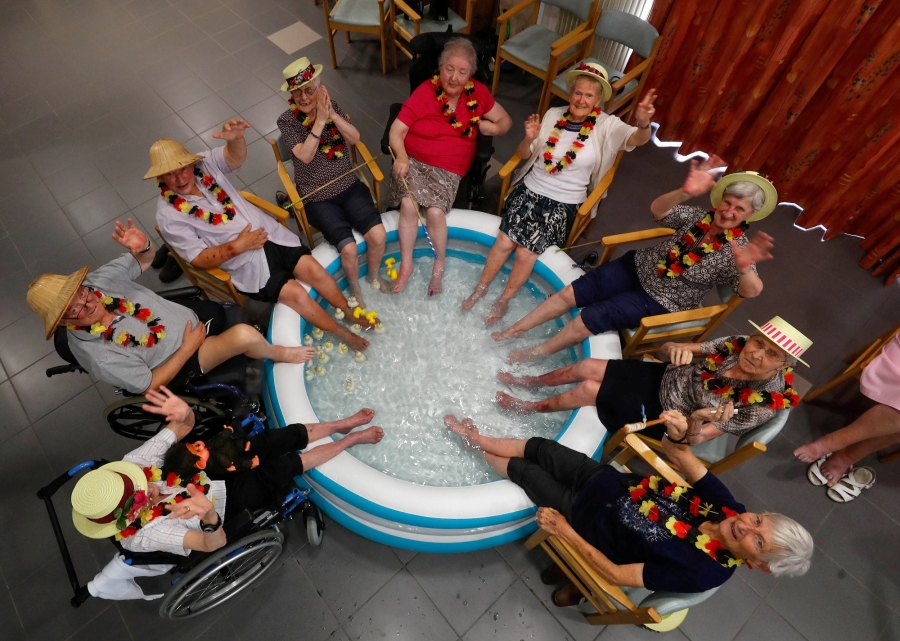 Residents at the Ter Biest house for elderly persons refresh their feet in a pool on a hot summer day, in Grimbergen, Belgium. Residents at the Ter Biest house for elderly persons refresh their feet in a pool in this over-head photograph.