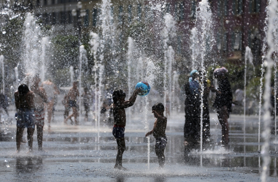 People cool off in water fountains in Nice, France. People cool off in water fountains in Nice, France.